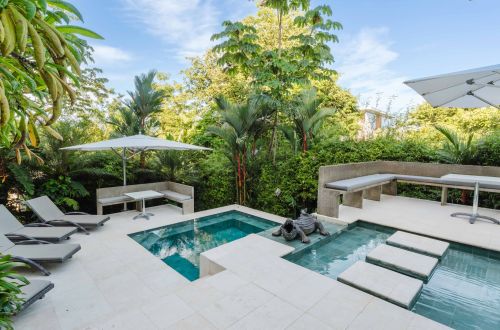 The two level swimming pool and deck areas with outdoor dining